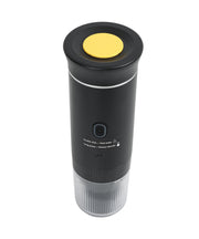 Black portable espresso maker bottom angle view showing yellow heating plate, control buttons, and textured grip base